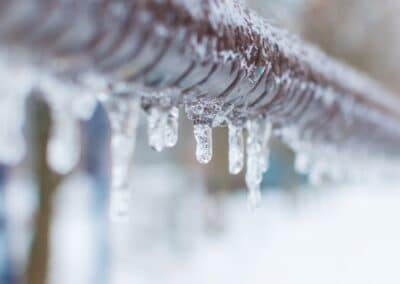 frozen icicles after rain on the pipe